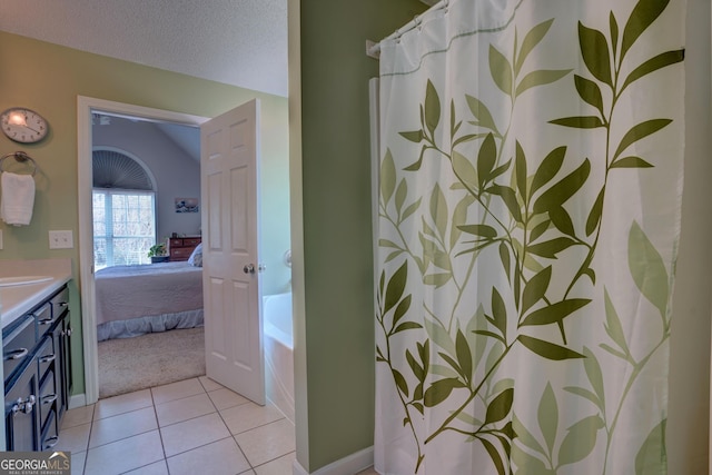 bathroom with vanity, tile patterned floors, a textured ceiling, and separate shower and tub