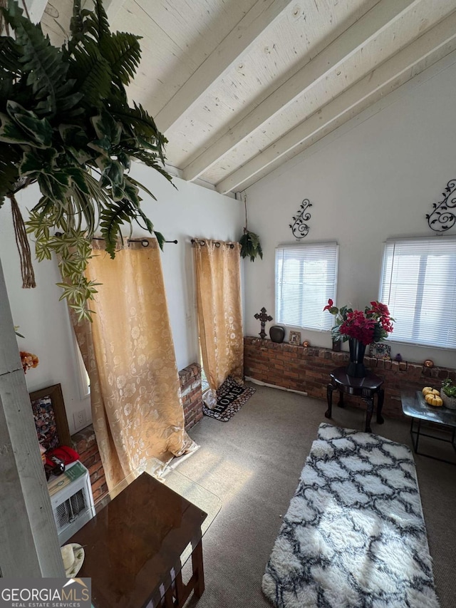 interior space featuring high vaulted ceiling, carpet flooring, and beam ceiling