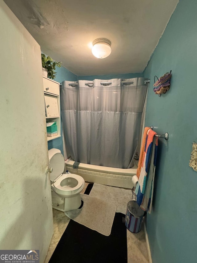 bathroom featuring shower / tub combo and toilet