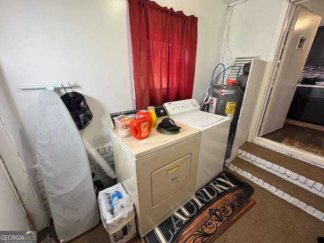 washroom featuring washing machine and dryer and electric water heater