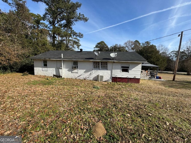 rear view of house with a yard