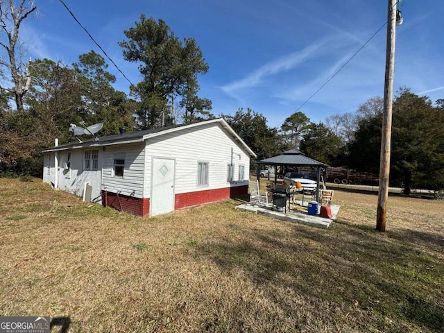 view of side of property with a gazebo and a yard