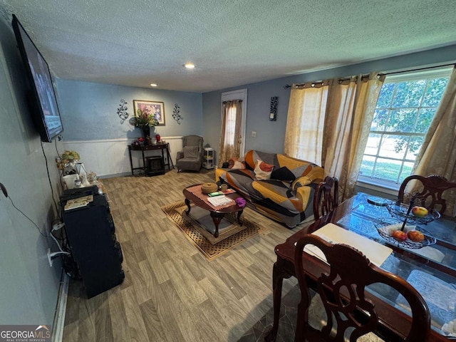 living room with hardwood / wood-style flooring and a textured ceiling