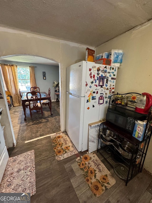 kitchen featuring a textured ceiling and white fridge