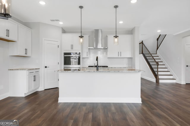 39 Pecan Ct, Hoschton, GA 30548 - kitchen with wall chimney exhaust hood, stainless steel oven, white cabinetry, light stone countertops, and recessed lighting