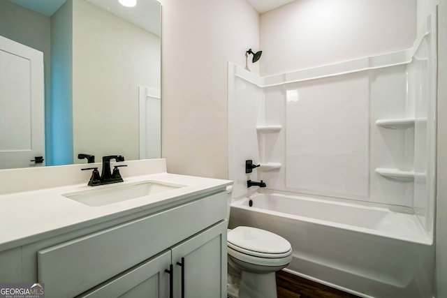 full bathroom featuring vanity, wood-type flooring,  shower combination, and toilet