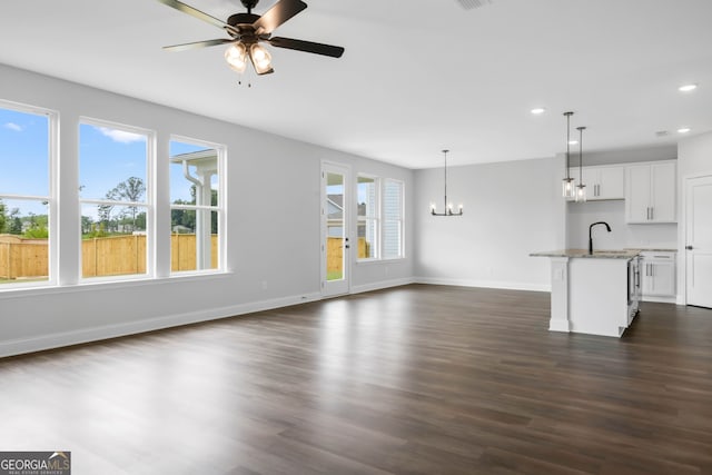 39 Pecan Ct, Hoschton, GA 30548 - unfurnished living room with a chandelier, recessed lighting, a ceiling fan, baseboards, and dark wood finished floors
