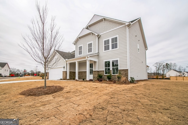 craftsman house featuring a garage and a front yard