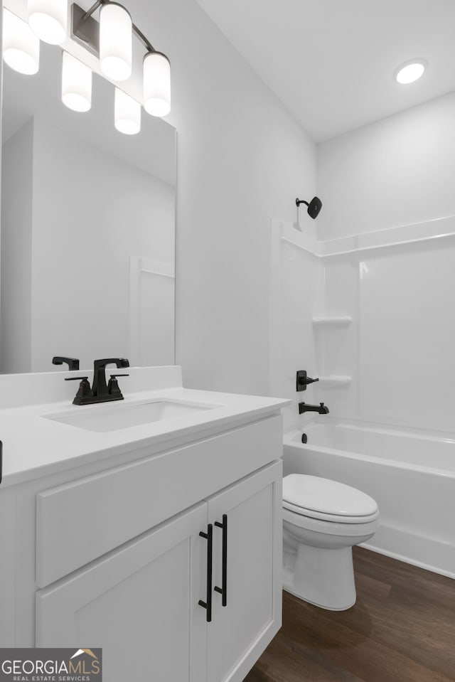 39 Pecan Ct, Hoschton, GA 30548 - full bathroom featuring wood finished floors, vanity, toilet, and tub / shower combination