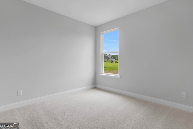 39 Pecan Ct, Hoschton, GA 30548 - empty room with light colored carpet, baseboards, and healthy amount of natural light