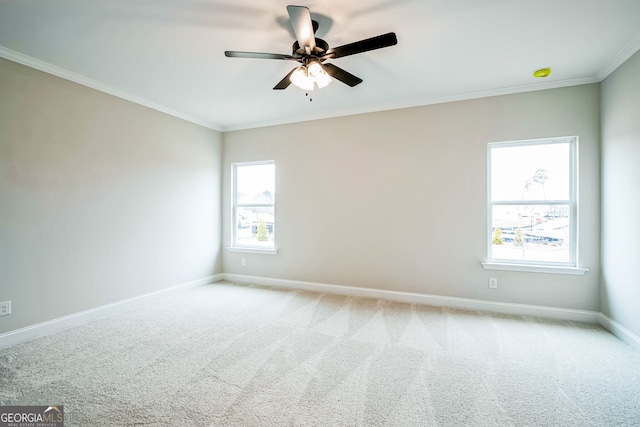 carpeted empty room with ornamental molding and ceiling fan