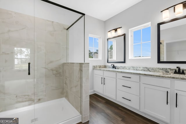 39 Pecan Ct, Hoschton, GA 30548 - full bathroom featuring a shower stall, wood finished floors, and double vanity
