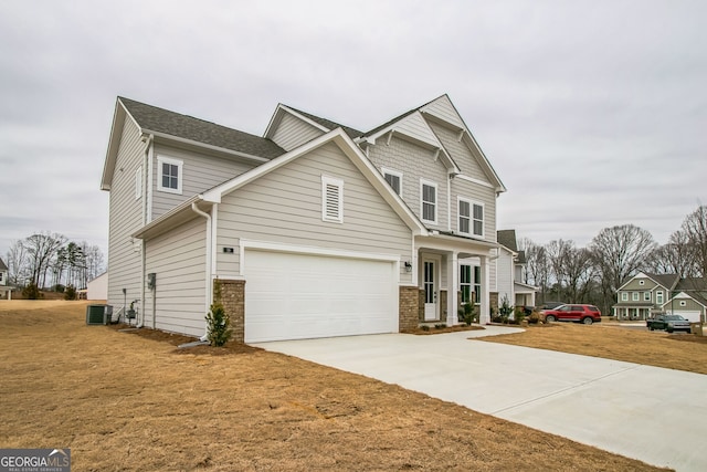 view of front of house featuring a garage, central AC, and a front lawn