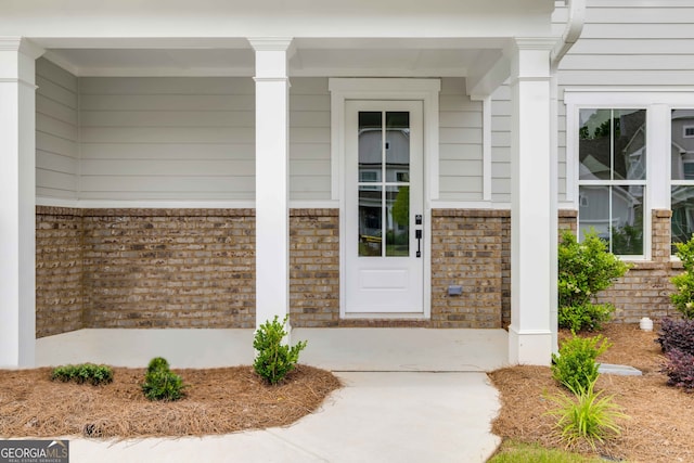 39 Pecan Ct, Hoschton, GA 30548 - view of exterior entry with brick siding and covered porch