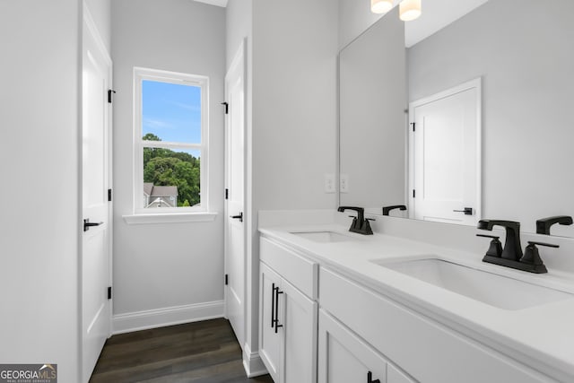 39 Pecan Ct, Hoschton, GA 30548 - bathroom with wood finished floors, double vanity, and baseboards