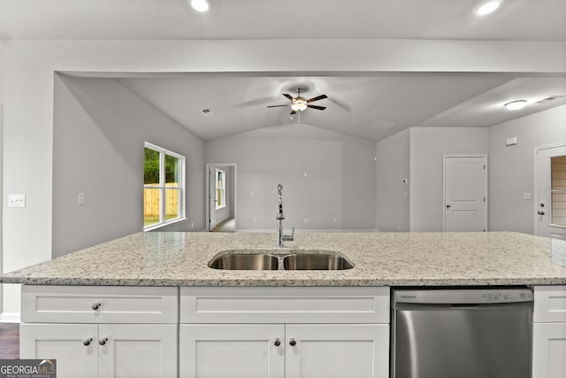 kitchen featuring dishwasher, sink, white cabinets, and light stone counters