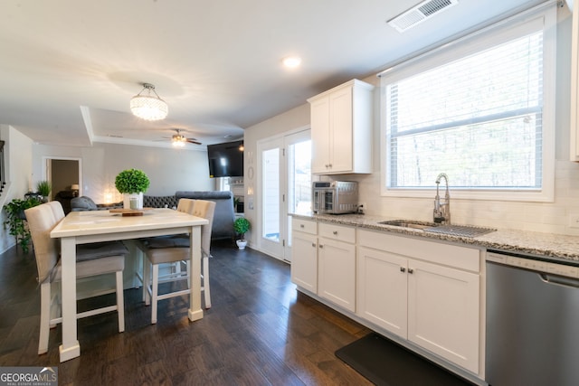 kitchen with white cabinetry, stainless steel dishwasher, light stone countertops, and sink