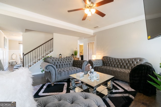 living room featuring hardwood / wood-style flooring, ornamental molding, and ceiling fan