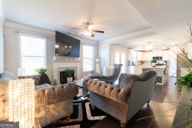 living room featuring crown molding, a high end fireplace, and dark wood-type flooring