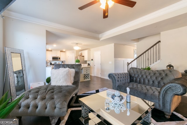 living room featuring ornamental molding, dark wood-type flooring, and ceiling fan