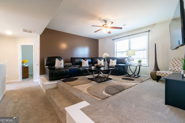 carpeted living room with ceiling fan