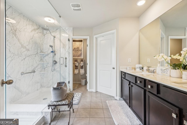 bathroom featuring tile patterned flooring, vanity, toilet, and a shower with shower door