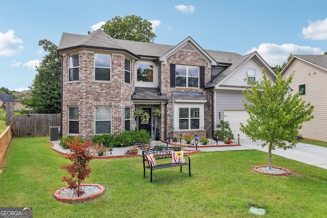 view of front of home with a garage, a front yard, and central air condition unit