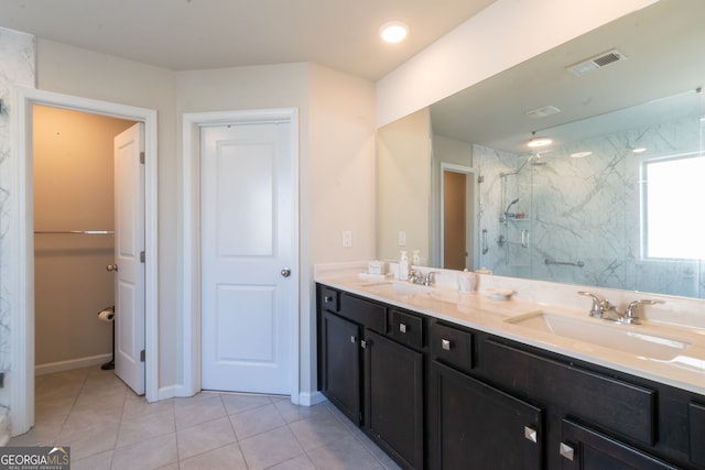 bathroom featuring tile patterned flooring, vanity, and a shower with shower door