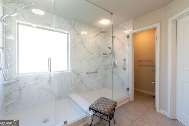 bathroom with tile patterned flooring and a shower with door