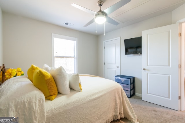 bedroom with ceiling fan and light carpet