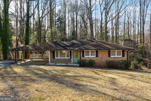 ranch-style house featuring a carport and a front yard