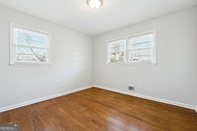 unfurnished room featuring hardwood / wood-style flooring