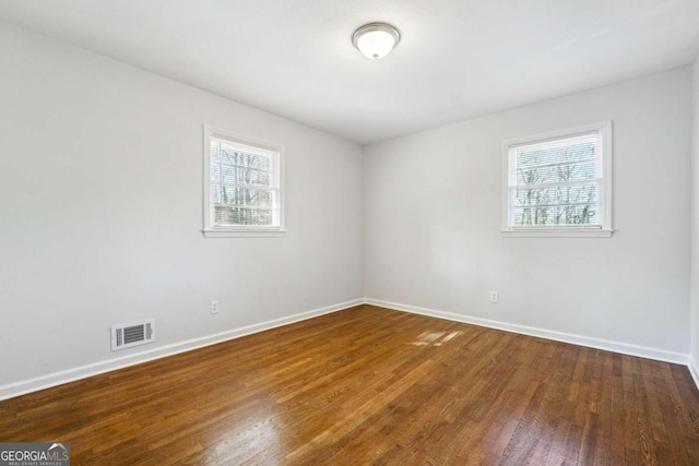 spare room with hardwood / wood-style floors