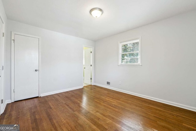 empty room featuring hardwood / wood-style flooring