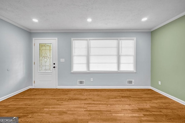 6467 Joanna St, Lithia Springs, GA 30122 - entryway featuring wood finished floors, a textured ceiling, recessed lighting, and crown molding
