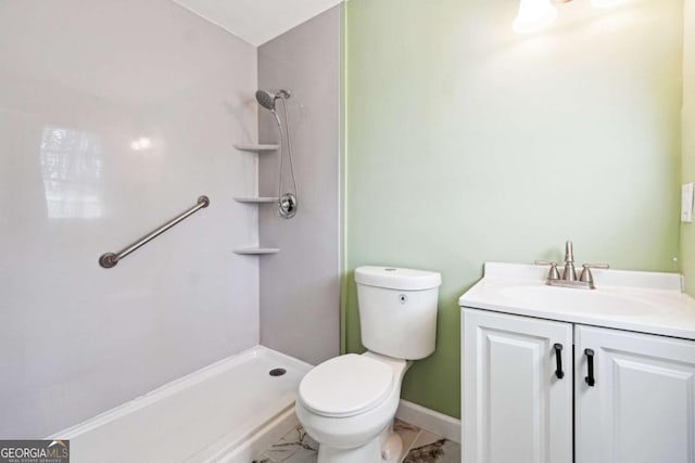 bathroom featuring vanity, toilet, and walk in shower