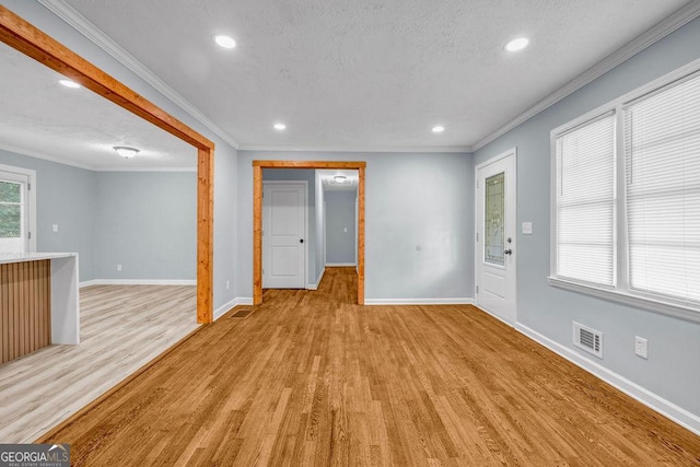 6467 Joanna St, Lithia Springs, GA 30122 - unfurnished living room with crown molding, light wood-style floors, recessed lighting, and a textured ceiling