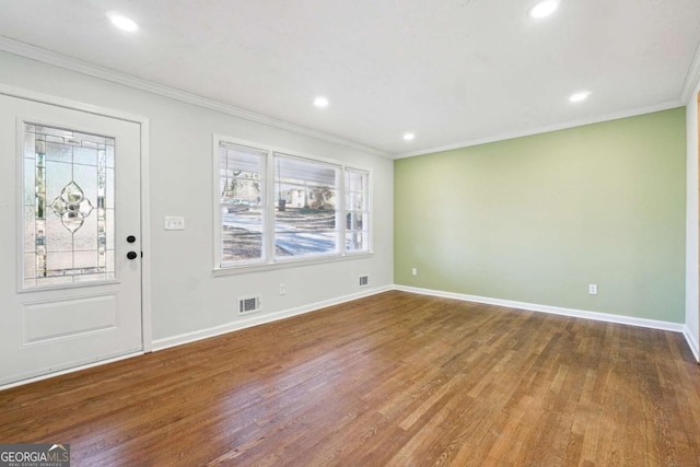 foyer with hardwood / wood-style flooring and ornamental molding