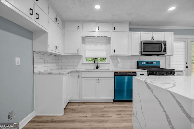 6467 Joanna St, Lithia Springs, GA 30122 - kitchen featuring dishwasher, gas range, stainless steel microwave, light stone countertops, and white cabinetry