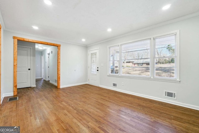 interior space featuring wood-type flooring and ornamental molding