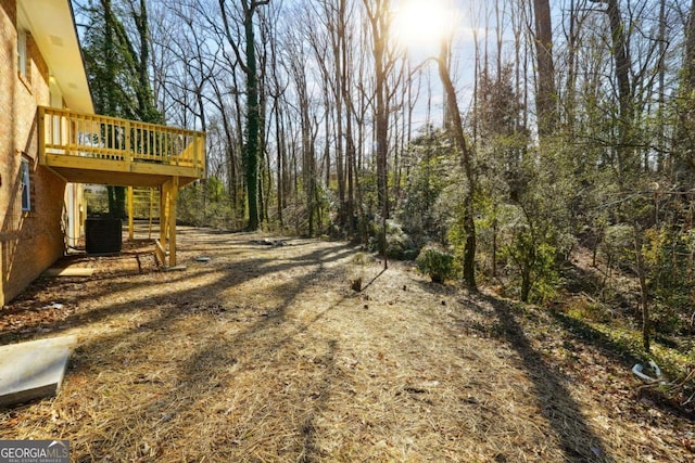 6467 Joanna St, Lithia Springs, GA 30122 - view of yard with central AC and a wooden deck