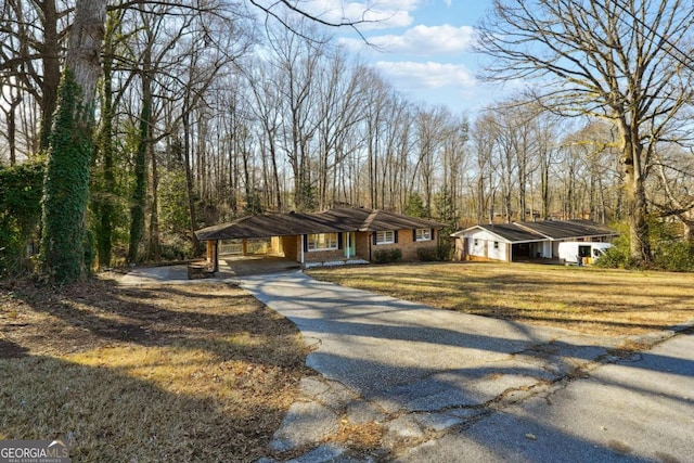 view of front facade with a carport and a front yard