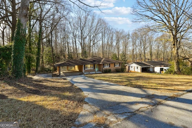 6467 Joanna St, Lithia Springs, GA 30122 - view of front facade with asphalt driveway, a carport, and a front yard