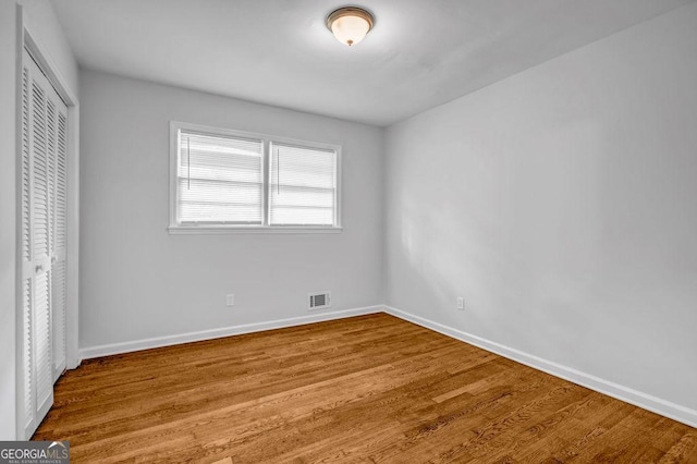 6467 Joanna St, Lithia Springs, GA 30122 - unfurnished bedroom with a closet and wood finished floors
