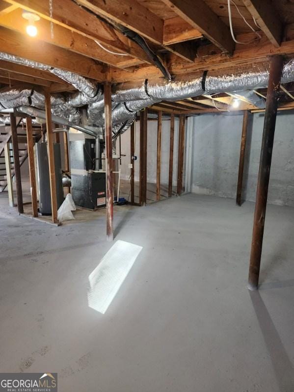 basement featuring heating unit and gas water heater