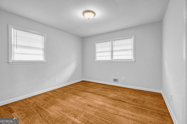 6467 Joanna St, Lithia Springs, GA 30122 - spare room featuring baseboards and wood finished floors