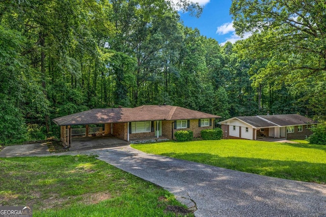 6467 Joanna St, Lithia Springs, GA 30122 - single story home featuring driveway, a carport, a front lawn, and a forest view