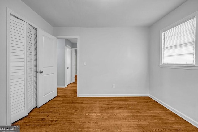 6467 Joanna St, Lithia Springs, GA 30122 - unfurnished bedroom with wood finished floors and a closet