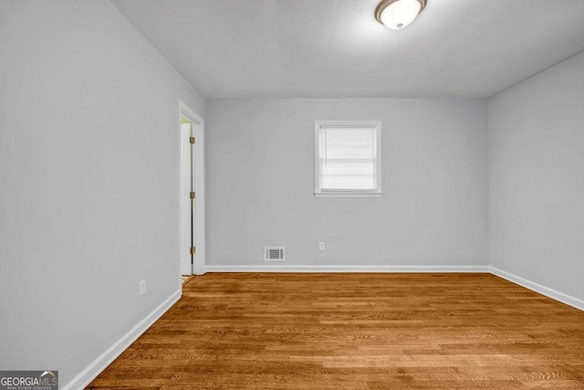 6467 Joanna St, Lithia Springs, GA 30122 - spare room featuring baseboards and wood finished floors