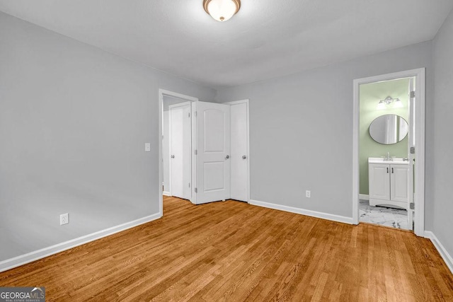6467 Joanna St, Lithia Springs, GA 30122 - unfurnished bedroom with light wood-style flooring and ensuite bathroom